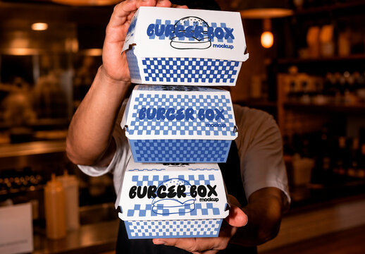 Man Holding Stacked Food Boxes Mockup