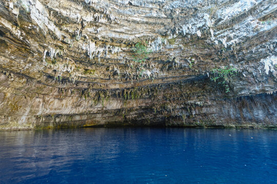 Blue water inside a cave, surrounded by rocks