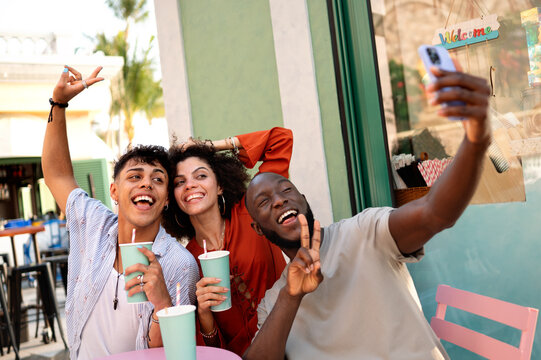 Young friends capture selfie for social media, enjoying time together while expressing creativity