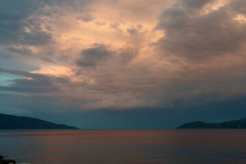 Fototapeta premium Dramatic clouds over the sea at sunset