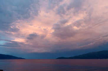 Obraz premium Serene sunset over the sea with pink and blue clouds, Agia Effimia, Kefalonia, Greece