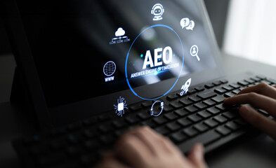 Obraz premium Modern Digital Interface Featuring Answer Engine Optimization Concept with Futuristic Icons and Hands Typing on Keyboard Fluxor.