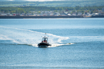 Fototapeta premium Motorboat Crossing the St. Lawrence River Near Rimouski, Quebec