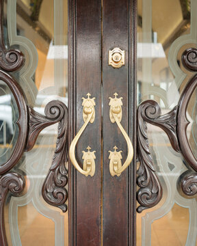 Elegant Vintage Wooden Door with Brass Handles