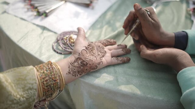 Mehndi Henna Applying on Bride Hands During Wedding Ceremony Showing Beautiful Traditional Art, Bridal Design, and Indian Cultural Celebration