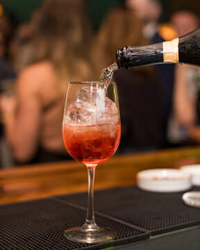 Refreshing Red Cocktail Being Poured at a Bar
