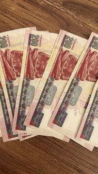 Stack of Egyptian pound notes on a cafe table, local currency, scattered coins, casual spending scene.