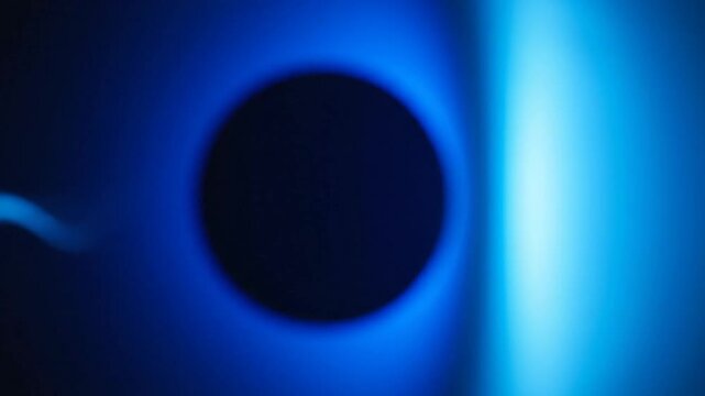 Dark circle with glowing blue light abstract background