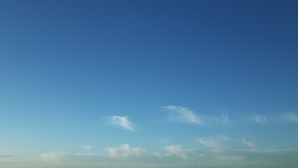 Obraz premium A Serene, Beautiful Blue Sky Graced with Wispy, Light Clouds Floating Gracefully Above