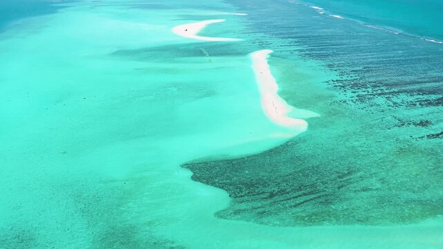 Aerial view of white sandbars and coral reefs surrounded by turquoise waters in Kudahuvadhoo, Dhaalu Atoll, Maldives.