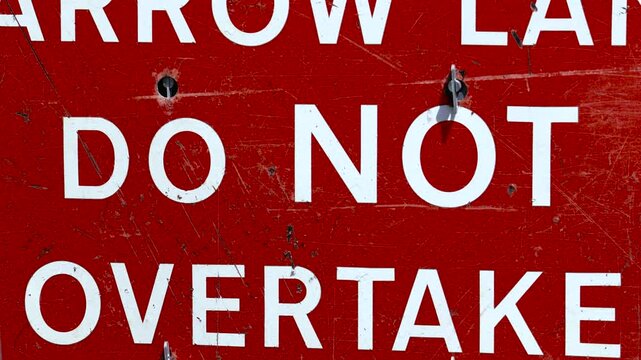 "NARROW LANE[S] DO NOT OVERTAKE CYCLISTS" Advisory Temporary Traffic Sign, Road Signage, London, United Kingdom | British Highway Code
