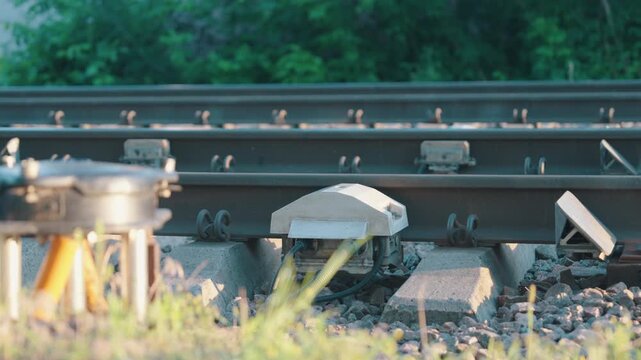 Infrared Train Brake Temperature Sensor Mounted on Railway Track | Slow Motion Close-Up Shot with Subtle Parallax Camera Movement | Railroad Safety Monitoring Technology