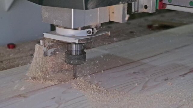 CNC machine cutting a pine board