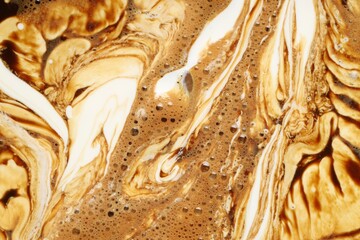 Naklejka premium Delicious coffee with milk and bubbles as background, top view