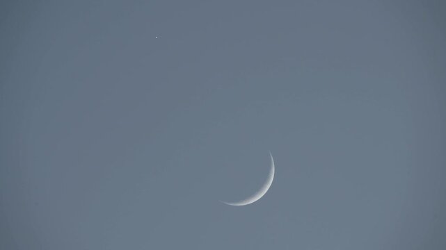 Telescope shot of rare alignment with waxing crescent moon and Venus
