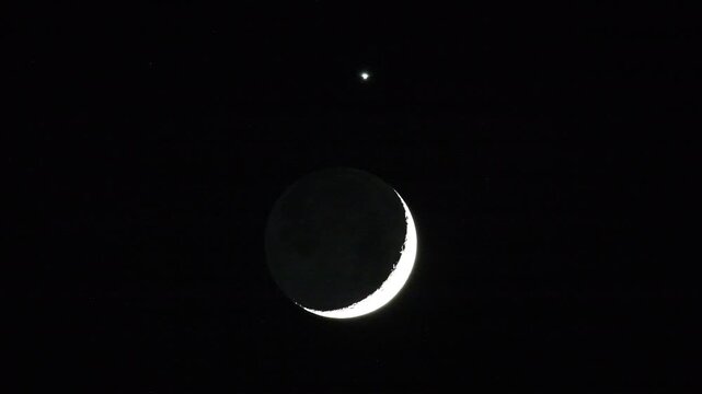 Telescope video of cosmic conjunction with crescent moon earthshine and Venus