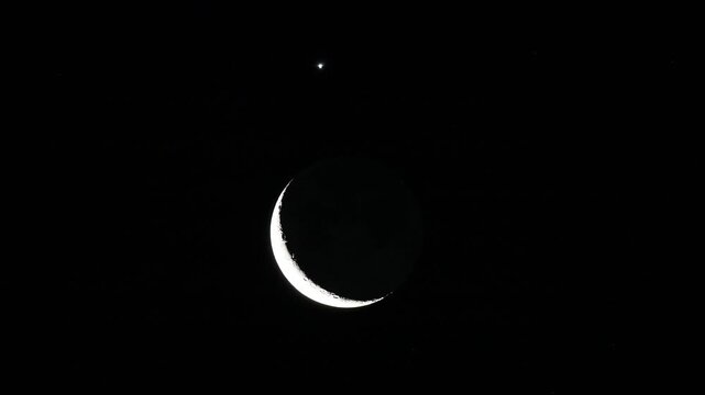 Super telephoto lens capture of celestial conjunction with waxing crescent moon and Venus