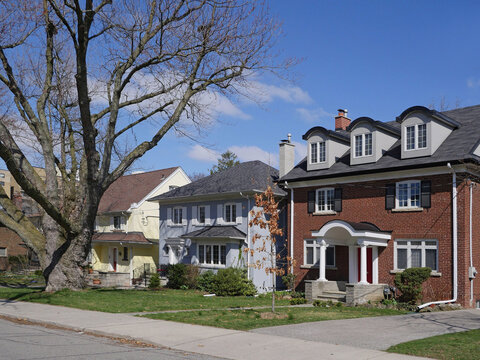 suburban middle class residential street with traditional brick detached houses