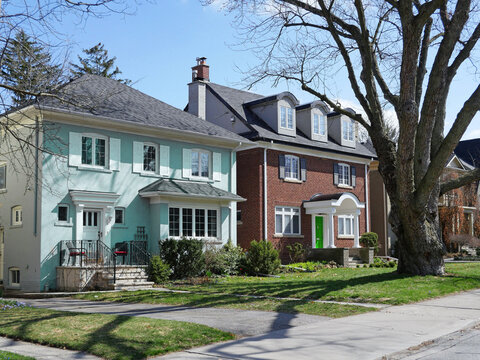suburban middle class residential street with traditional brick detached houses