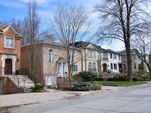 suburban middle class residential street with traditional brick detached houses
