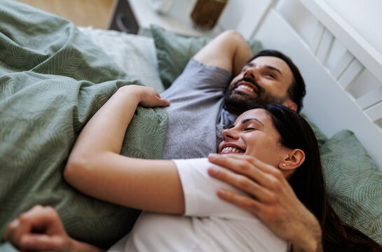 Couple enjoys time together in bed