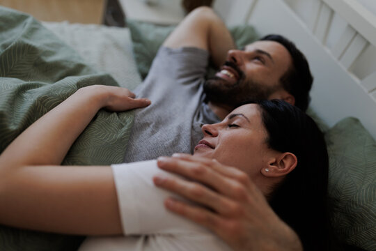 Couple enjoys time together in bed