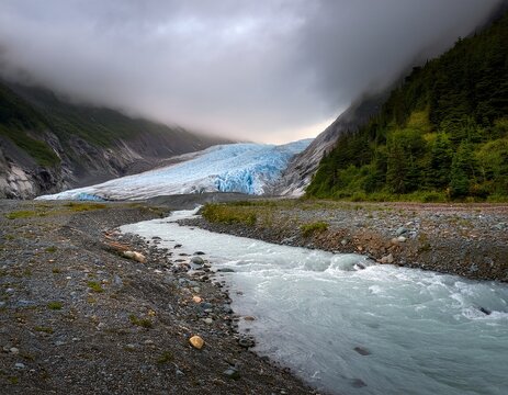 glacier with stream runoff and grey misty sky alaska