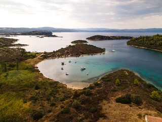 Fototapeta premium Blue Lagoon in Halkidiki near Diaporos Island, Sithonia, Halkidiki, Greece. Incredible beach with clear blue water. Aerial panoramic drone view from above, top view from drone. Summer holidays Europe