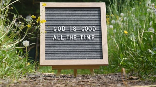 Letterboard with religious quote God is good in summer forest