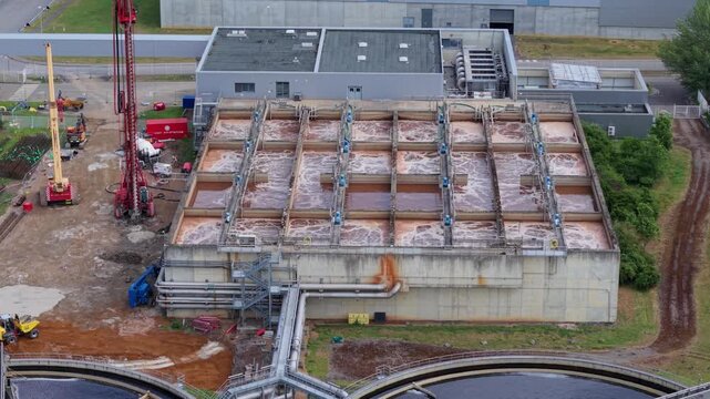Aerial view of the water treatment basins at Palm Paper Industrial Factory with bubbling liquid and industrial pipes in King's Lynn, England, United Kingdom.