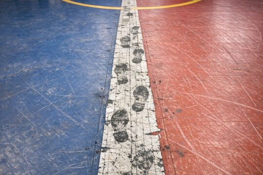 A blue and red floor with a line of footprints, perfect for illustrations about journey or pathfinding