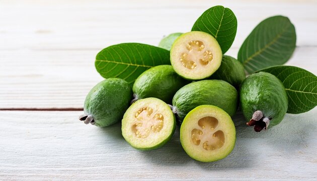 green feijoa fruit cut feijoa leaf acca sellowiana pile on white wooden background tropical feijoa or pineapple guava fruit exotic green fruit raw acca sellowiana plant guavasteen green fruit