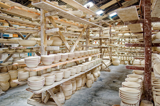 Ceramic dishes being dried on shelves in a traditional ceramic warehouse in the city of Carmen de Vilboral, Colombia.