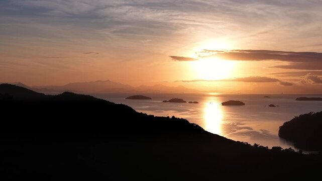 Golden Coast Sunset with Island Silhouettes