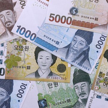South Korean won money bills pile on table. South Korea banknotes of KRW currency close up.