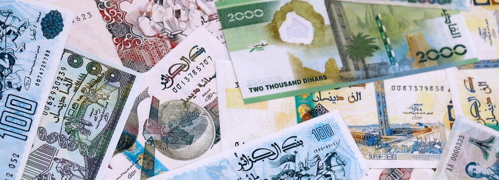 Algerian dinar money bills pile on table. Algeria banknotes of DZD currency close up.