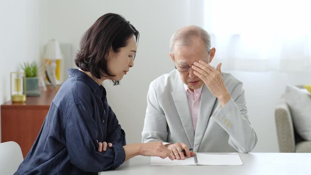 ノートに記入する高齢者の男性