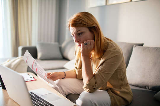 Worried woman reviewing utility bill at home