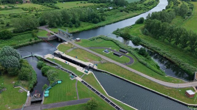 Aerial view of Denver Sluice complex featuring river locks, water channels, and lush green surroundings in Downham Market, England, United Kingdom.