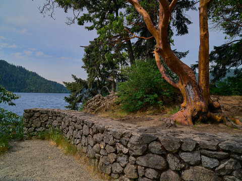 Stone retaining wall infrastructure along lake shoreline path