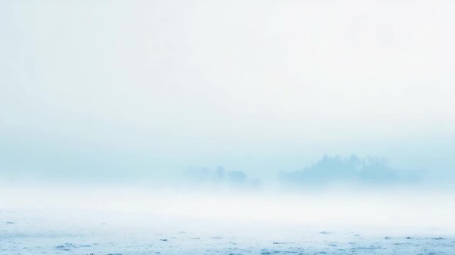 Misty winter landscape with a serene frozen lake and distant trees barely visible through the dense fog. Soft blue and white tones create a tranquil, dreamy atmosphere perfect for peaceful themes
