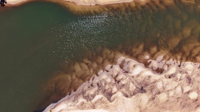 Direct Above View of Golden Sand and Blue Water