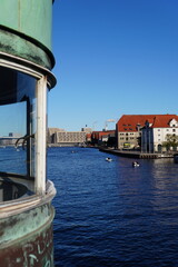 Aged Copper Bridge Structure with Copenhagen Harbour and Warehouses in Background, Denmark © helen