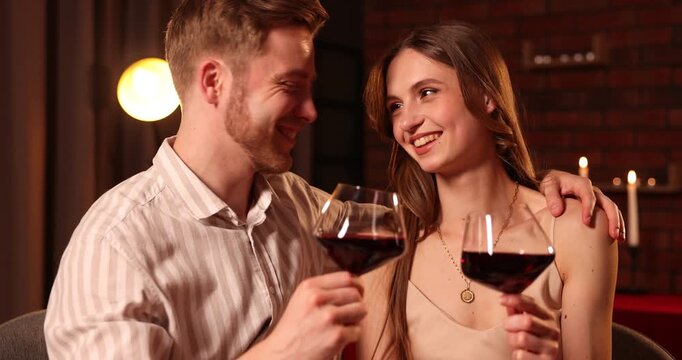 Romantic date. Couple clinking glasses of red wine in restaurant