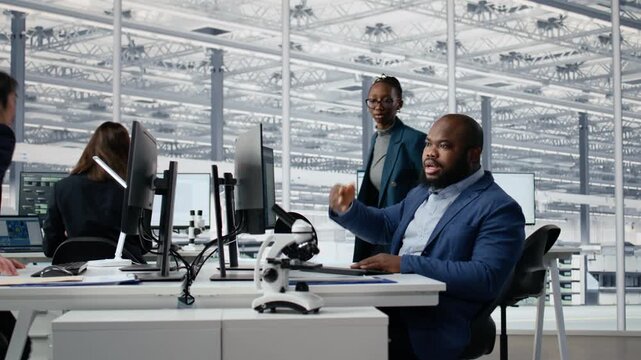 Optimizing production, microchip and diverse men with women in factory working together, improving semiconductor processing efficiency, computer and Teamwork coworkers for semiconductor research.