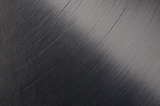 Diagonal Light Reflection on Black Vinyl Record Surface Close Up Abstract Texture