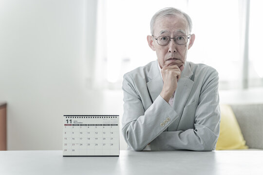 カレンダーを眺める高齢者の男性