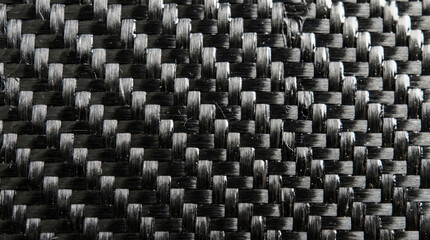 Fototapeta premium Close-up of woven black and gray carbon fiber pattern.