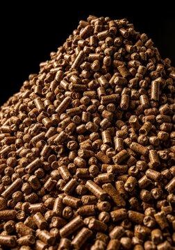 Large pile of small compressed wood pellets ready for use in industrial burners or household heating systems. Renewable energy source, agriculture, ecology, fuel