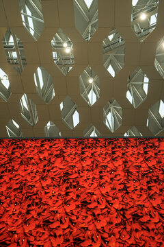 Focus at white structure of steel with red flower background.